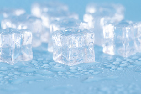 Ice cubes on a blue background. Selective focus. Shallow depth of fieldの写真素材
