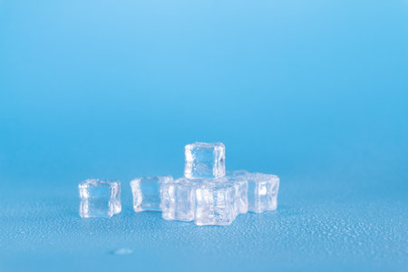 ice cubes on blue background, shallow depth of field, copy spaceの写真素材