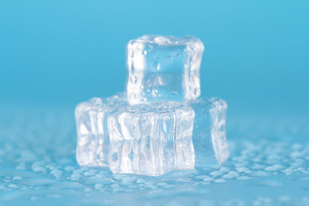 Ice cubes on a blue background. Shallow depth of field.の写真素材