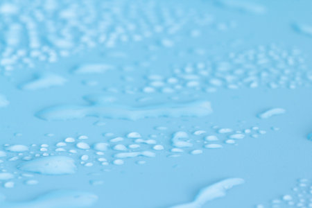 Water drops on a blue background close-up. Abstract background for design.の写真素材