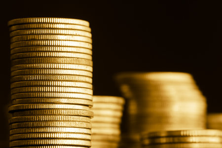 Stacks of gold coins on dark background. Shallow DOFの写真素材