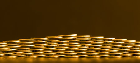 Stack of golden coins on black background. Business, finance and saving concept.の写真素材