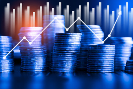 Stacks of coins with financial graph background, business and finance concept idea.の写真素材