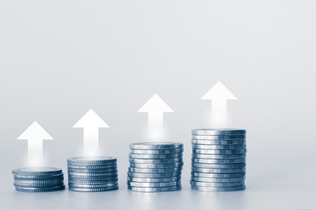 Stacks of coins on white background with copy space, business and finance concept idea.の写真素材