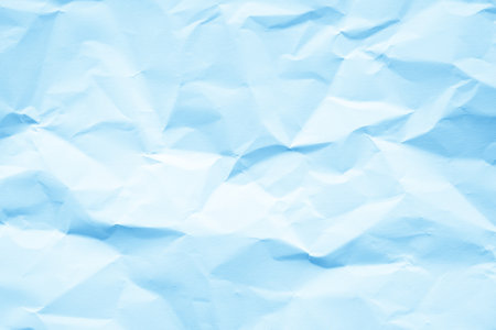Crumpled paper texture. Blue paper background for design with copy space.の写真素材