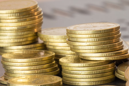 golden coins on the background of a business chart close-upの写真素材