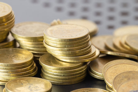Close up of golden coins on black background, business and finance conceptの写真素材
