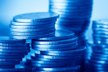 Stacks of coins on blue background, business and finance concept.の写真素材