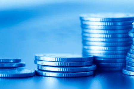 Stacks of coins with shallow depth of field. Blue tone.の写真素材