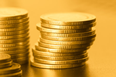 Coins stacked on each other in different positions, closeup of photoの写真素材