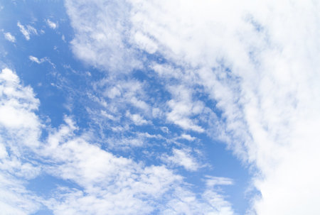 Blue sky background with white clouds. White fluffy clouds in the blue sky.