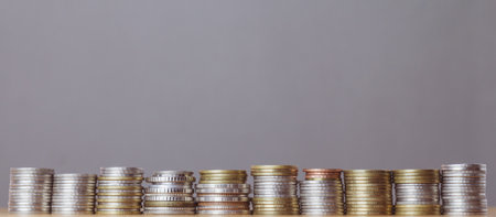 Stacks of coins on gray background, business and finance concept.