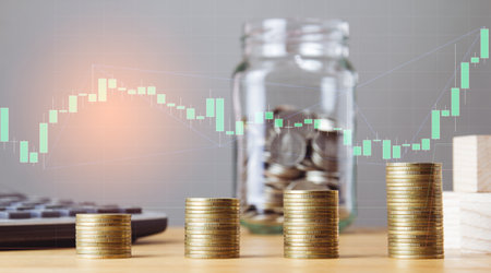 Double exposure of coins stacks and glass jar with financial graph, business and investment conceptの写真素材