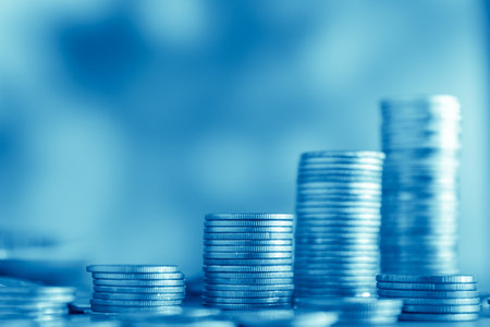Stacks of coins on blue background, business and finance concept idea.の写真素材