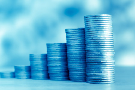 Stacks of coins on blue background, business and finance concept.の写真素材