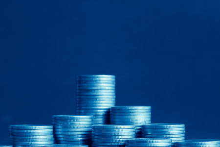 Stacks of coins on blue background, business and finance concept idea.の写真素材