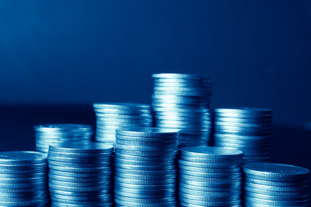 Stacks of coins on a dark blue background. Toned.の写真素材
