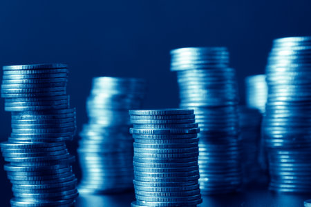 Coins stacked on each other in different positions. Blue tone.の写真素材
