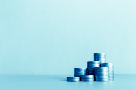 Coins stacks on blue background, business and finance concept idea.の写真素材