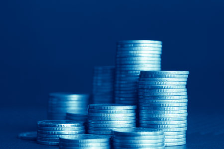 Coins stacked on each other in different positions. Blue tone.の写真素材