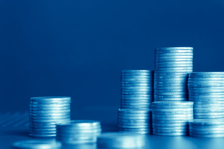 Coins stacked on each other in different positions. Blue tone.の写真素材