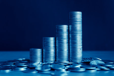 Stacks of coins on a dark blue background with copy space.の写真素材