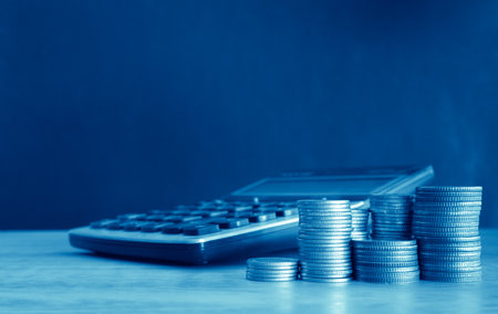 calculator and stack of coins for finance and banking concept idea.