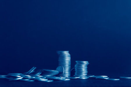 Stacks of coins on dark blue background, business and finance concept idea.