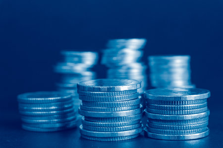 Stacks of silver coins with blue background, business and finance concept idea.の写真素材