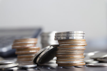 Stacks of coins and calculator on table, business and finance conceptの写真素材