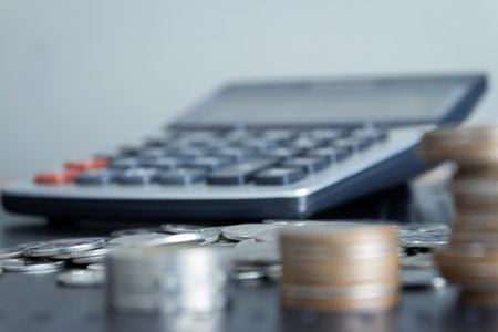 calculator and coins on the table, business and finance concept