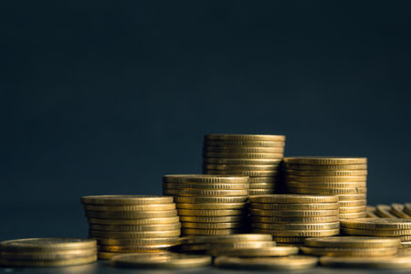 Stacks of gold coins on dark background, business and finance concept idea.の写真素材
