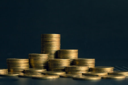 Stacks of gold coins on dark background, business and finance concept idea.の写真素材