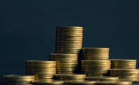 Stacks of gold coins on dark background. Business and finance concept.の写真素材