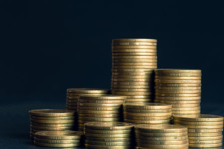 Stacks of gold coins on dark background, business and finance concept idea.の写真素材