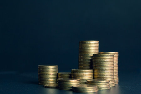 Stacks of coins on dark blue background, business and finance conceptの写真素材