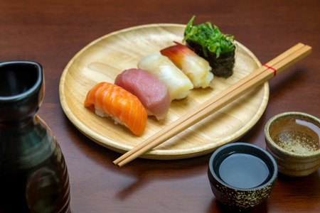 sake cup with sushi backgroundの写真素材