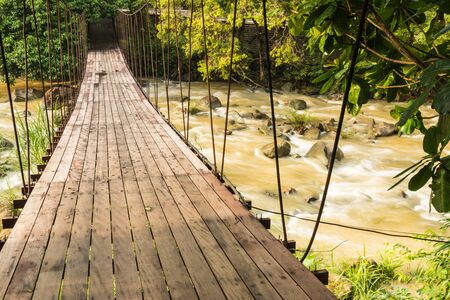 small Rope bridge over nature stream in parkの写真素材