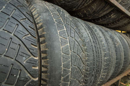 secondhand tire on yellow wallの写真素材