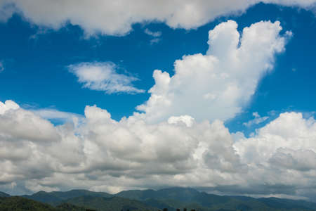 cumulus cloud in blue sky over mountainの写真素材