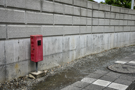 old mailbox beside cement wallの写真素材