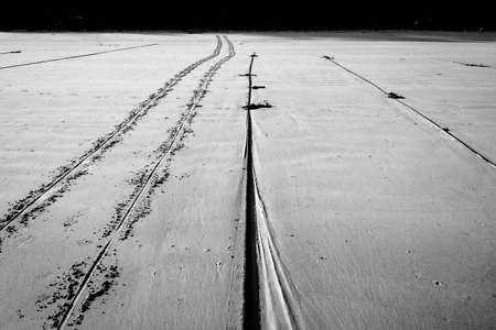 wheel track and rope on beachの写真素材