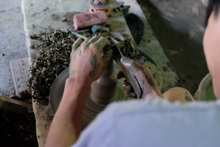 Human making pottery