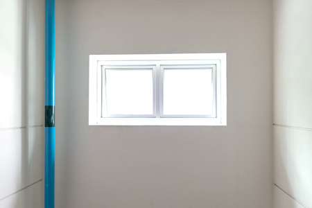 Blue pvc pipe and small window at toilet