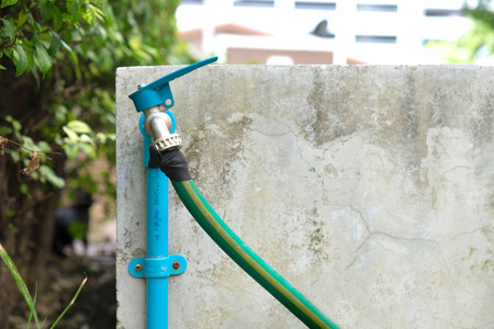 Faucet and green water hoseの写真素材