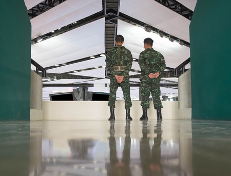 two army standing in sport dome