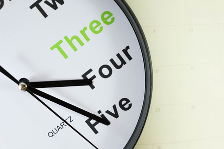 analog clock put on empty notebook paperの写真素材