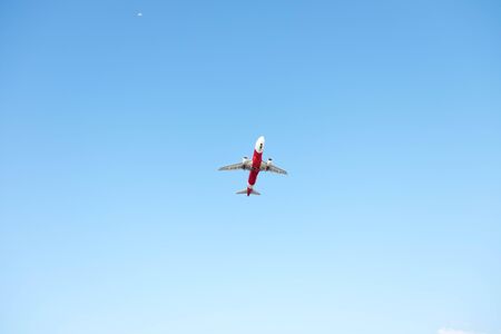 Airplane flying on blue skyの写真素材