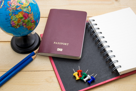 top view travel accessory prepare for planning holiday on wooden floor backgroundの写真素材