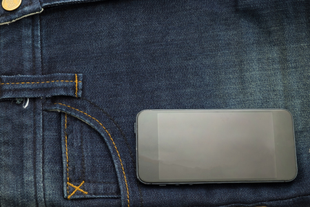 rather old blue jean have stripe and smart phone put on pocket sideの写真素材